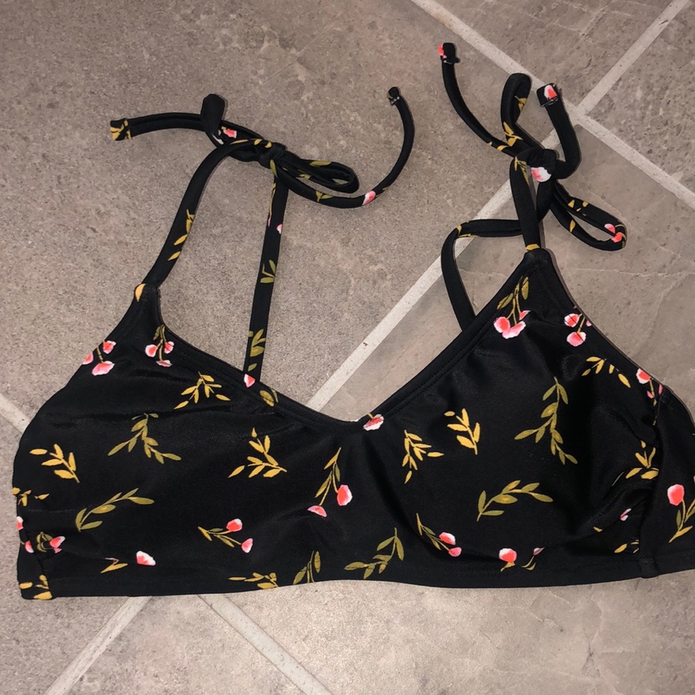 Black swimsuit top with leaves and flowers